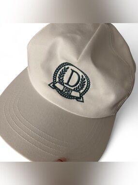 White Danzy hat with green embroidery